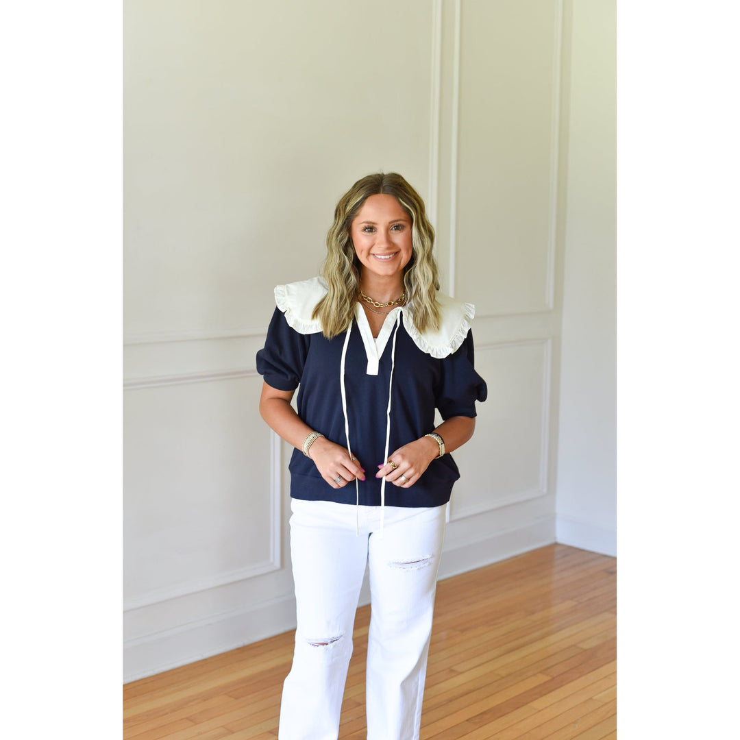 navy top with with ruffle collar