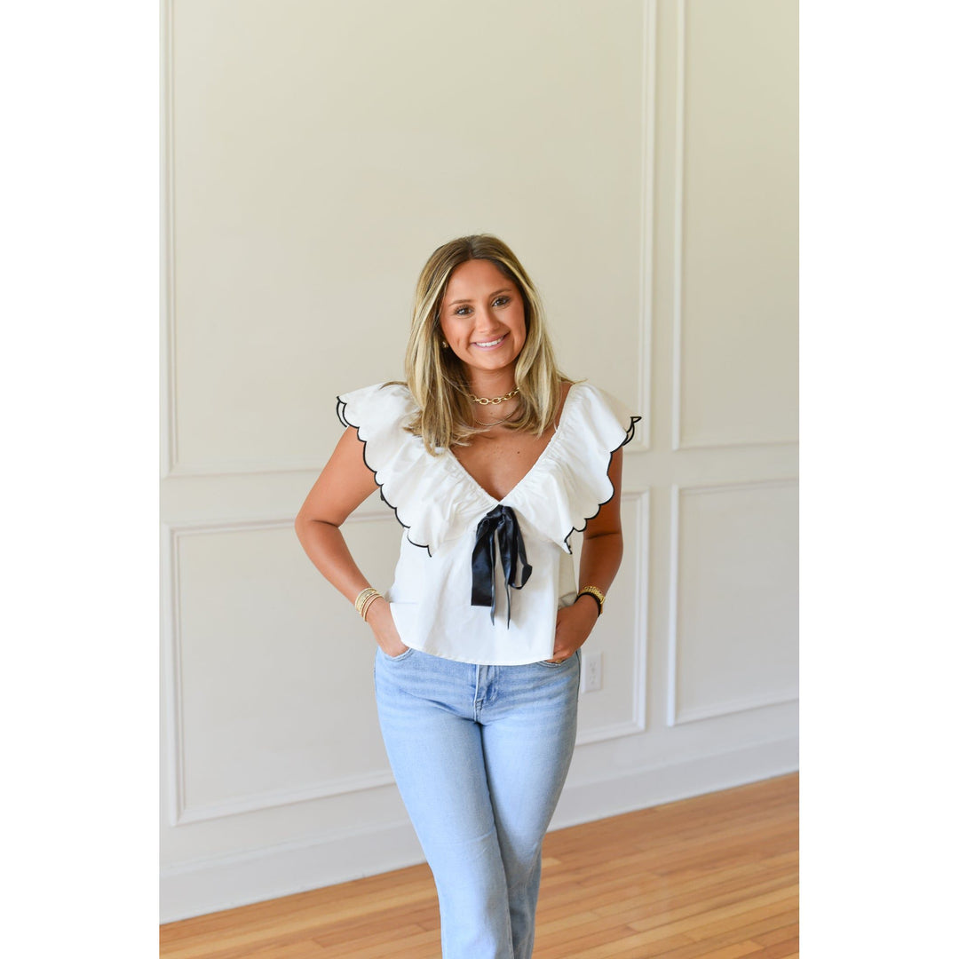 White and black top with scalloped sleeve