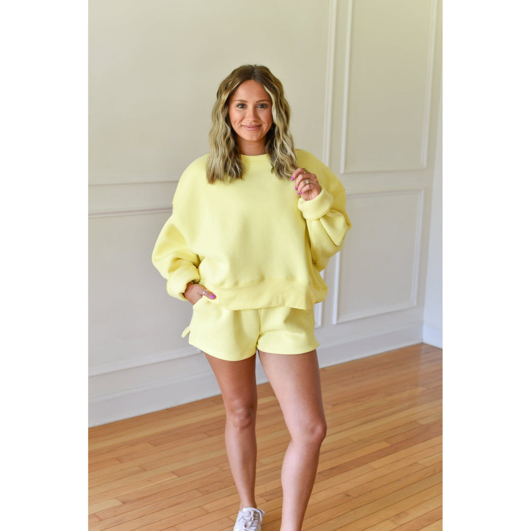 yellow shorts and sweatshirt